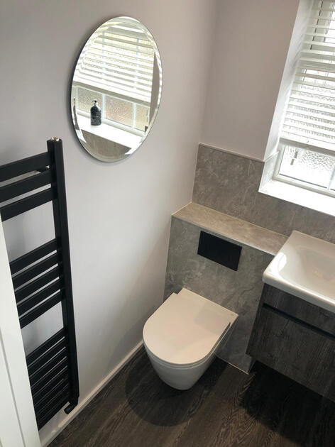 Showroom renovation with wall hung pan and shower panelling Aston Bampton witney